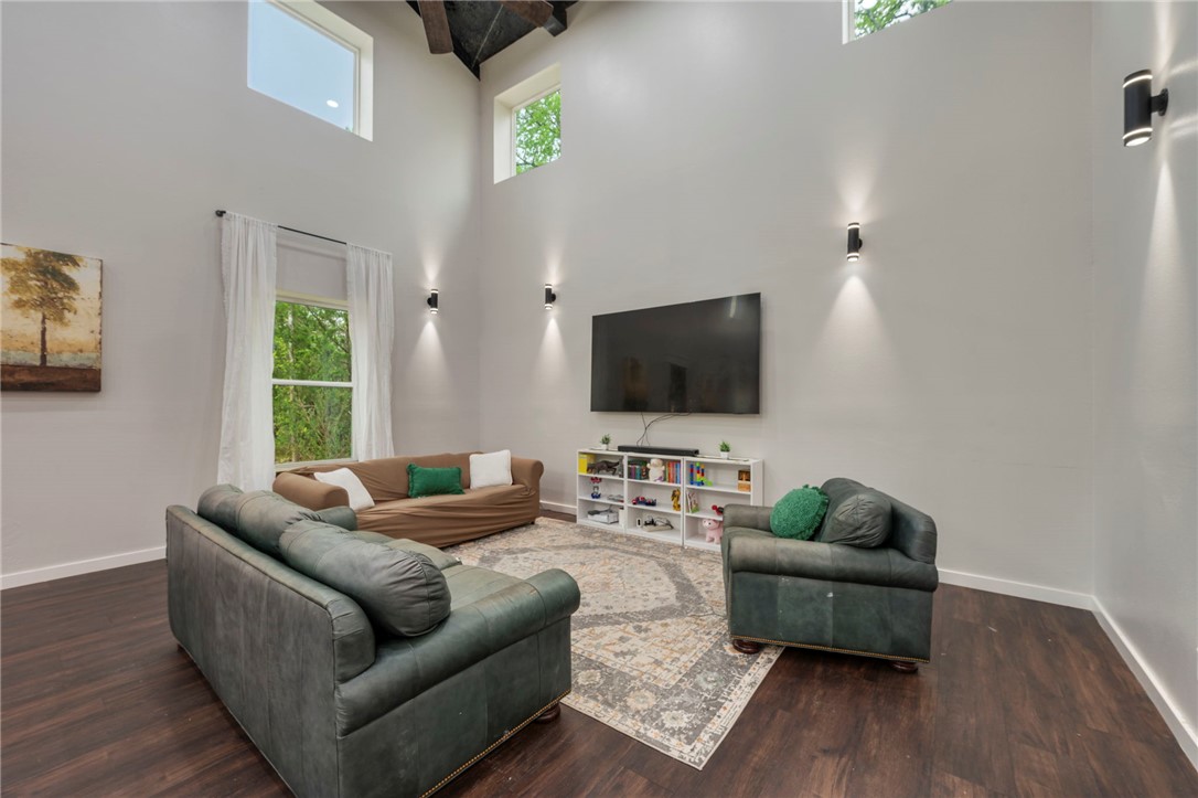 3915 County Road 447 Anderson, TX 77830 - Photo 3 of 40 a living room with furniture and a flat screen tv