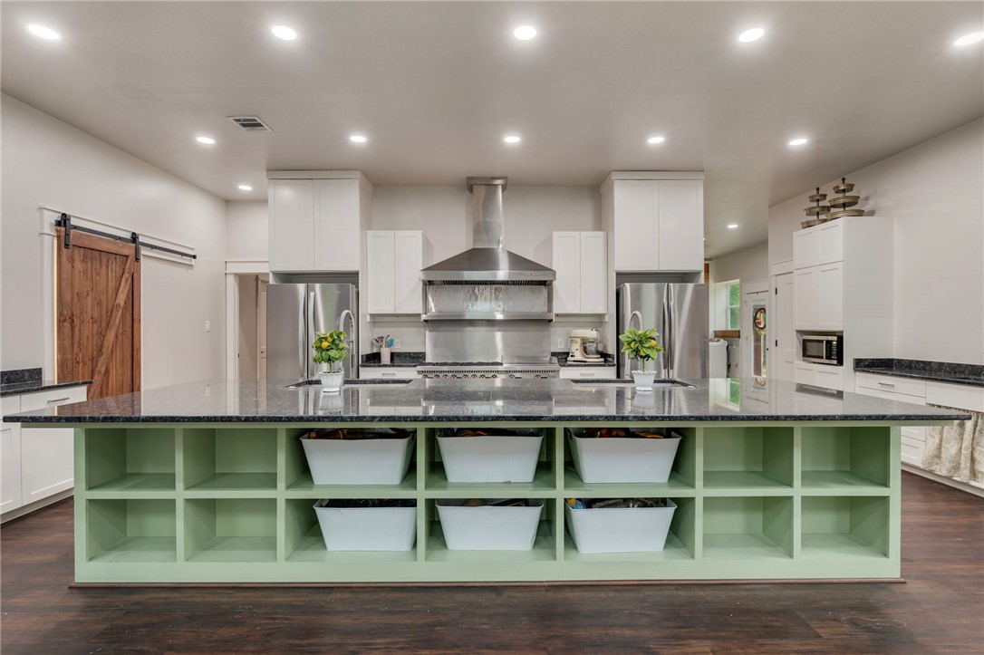 3915 County Road 447 Anderson, TX 77830 - Photo 6 of 40 a kitchen with kitchen island stainless steel appliances a sink and cabinets