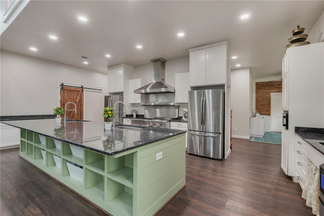 3915 County Road 447 Anderson, TX 77830 - Photo 7 of 40 a kitchen with stainless steel appliances granite countertop a refrigerator a stove a sink and a oven