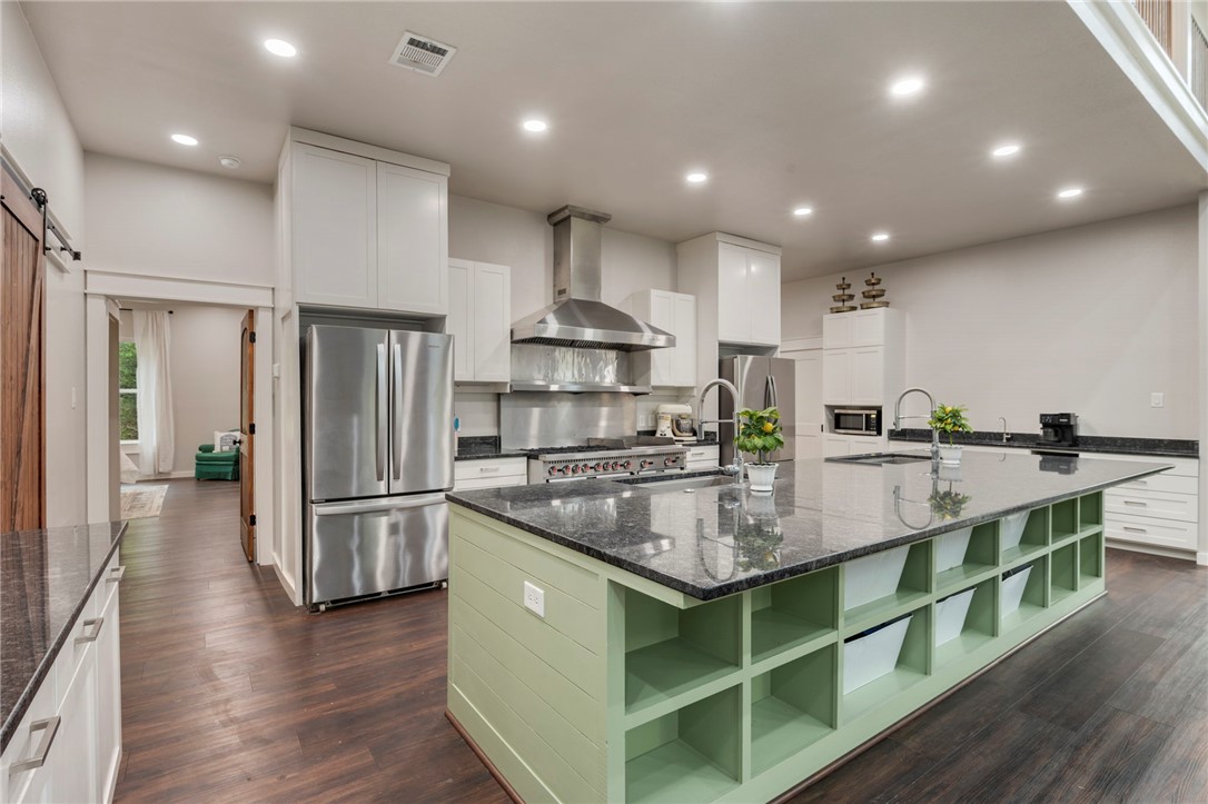3915 County Road 447 Anderson, TX 77830 - Photo 8 of 40 a kitchen with kitchen island stainless steel appliances a sink refrigerator and cabinets