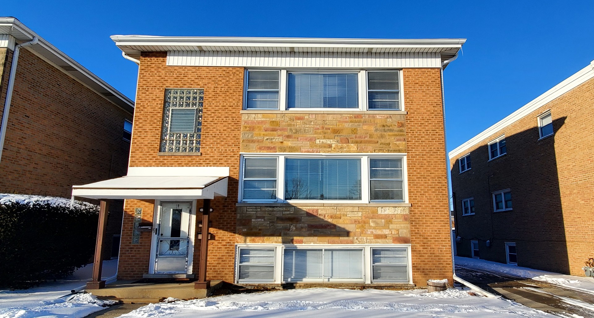 7252 West Crain Street, Unit 1 Niles, IL 60714 - Photo 1 of 11 a front view of a house with glass windows and table
