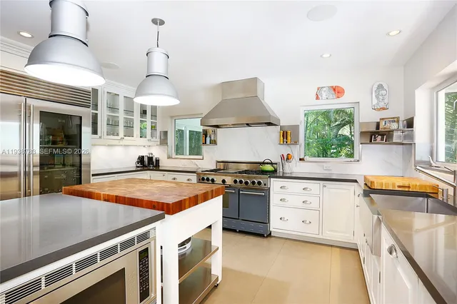 a kitchen with stainless steel appliances granite countertop a stove and a sink