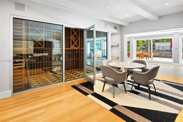 a dining room with furniture and wooden floor