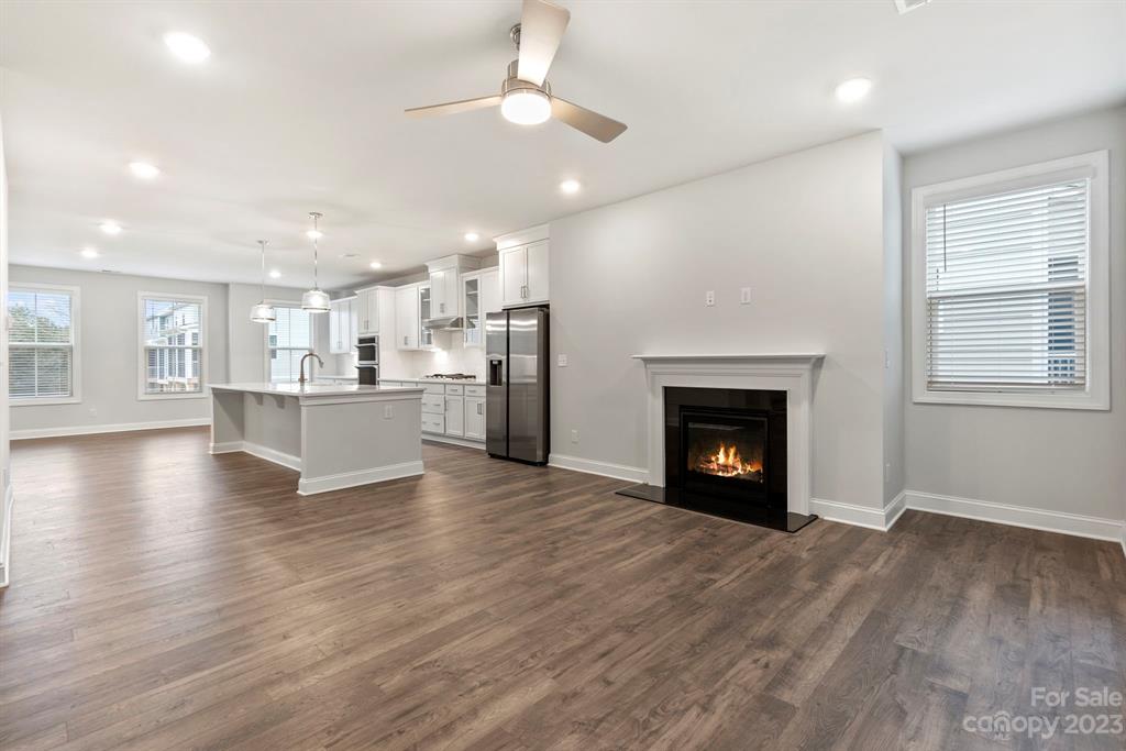 3753 Keyworth Way Lexington, SC 29072 - Photo 16 of 18 a view of an empty room with wooden floor a fireplace and a window