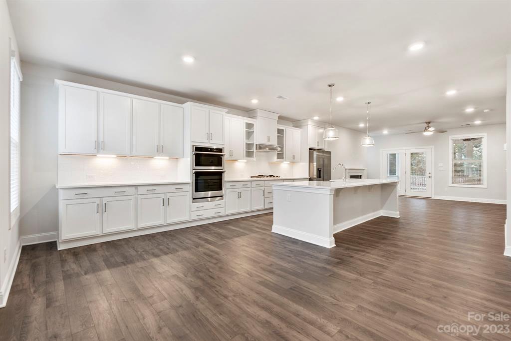 3753 Keyworth Way Lexington, SC 29072 - Photo 18 of 18 a large kitchen with stainless steel appliances granite countertop a large counter top and a stove with wooden floor