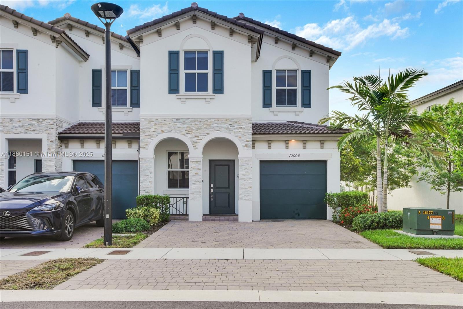 a front view of a house with a yard and garage