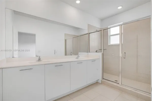 a bathroom with double sink and a mirror
