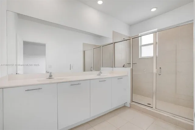 a bathroom with double sink and a mirror