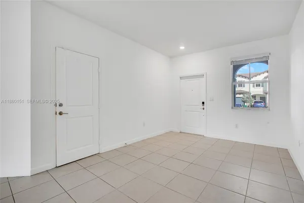a view of an empty room and closet area