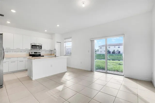 a kitchen with cabinets and appliances