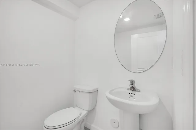 a bathroom with a sink a mirror and a toilet