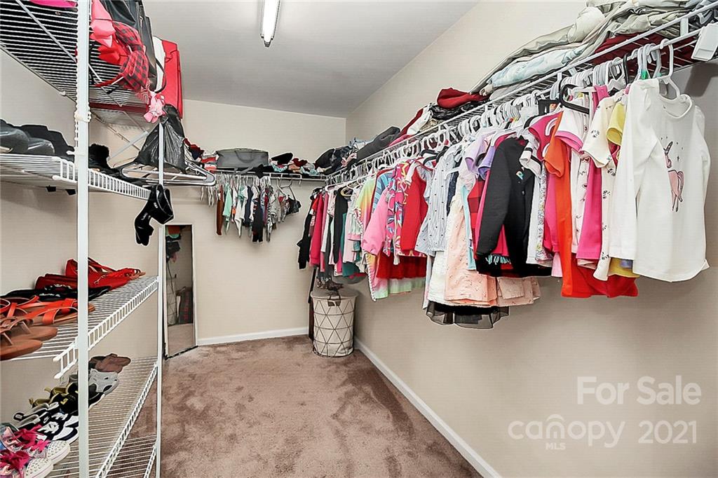 11516 Erwin Ridge Avenue Charlotte, NC 28213 - Photo 21 of 38 a view of walk in closet with clothes