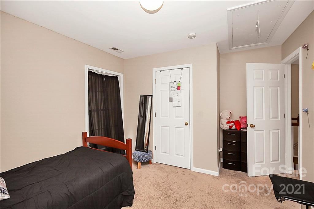 11516 Erwin Ridge Avenue Charlotte, NC 28213 - Photo 23 of 38 a bedroom with a bed and a mirror