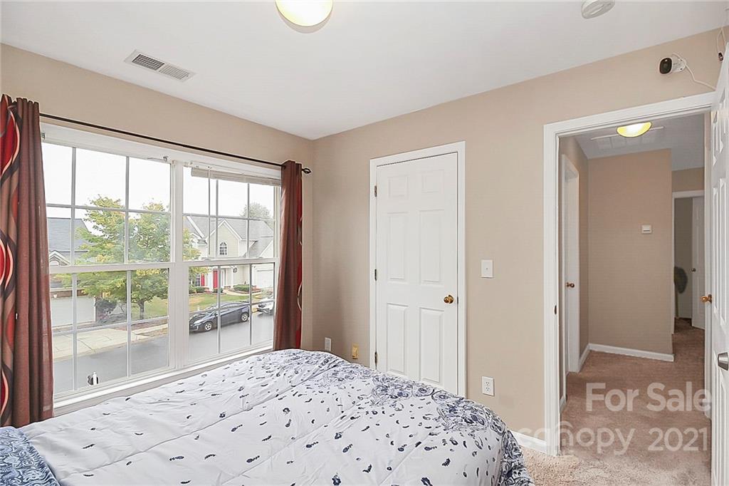 11516 Erwin Ridge Avenue Charlotte, NC 28213 - Photo 25 of 38 a bedroom with a bed and a large window