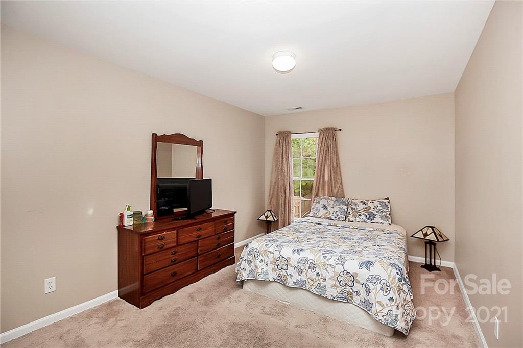 11516 Erwin Ridge Avenue Charlotte, NC 28213 - Photo 26 of 38 a bedroom with a bed and a flat screen tv