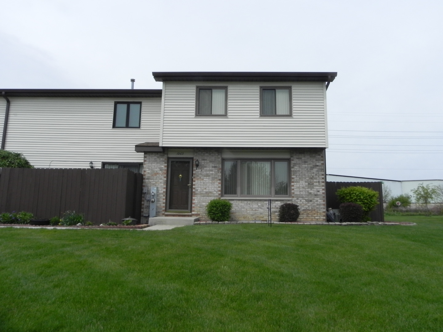 1065 Southgate Road, Unit 1065 New Lenox, IL 60451 - Photo 1 of 1 a house view with a garden space