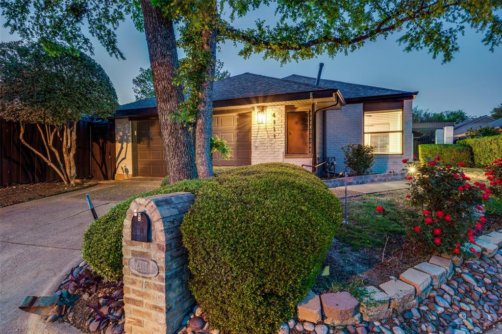 4111 Rush Circle Addison, TX 75001 - Photo 1 of 1 View of front facade featuring brick siding, fence, concrete driveway, and roof with shingles