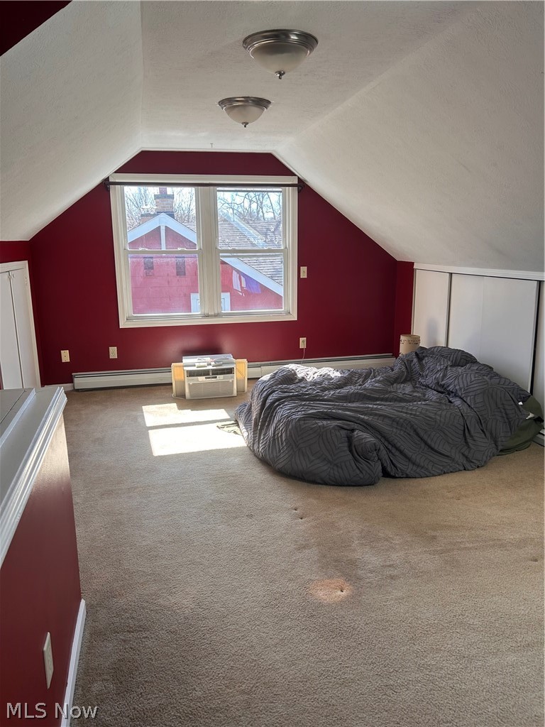 1001 Englewood Road Cleveland Heights, OH 44121 - Photo 21 of 28 Bedroom featuring carpet, a baseboard radiator, and a textured ceiling