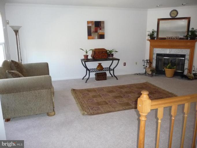 12120 Apache Tears Circle Laurel, MD 20708 - Photo 2 of 30 a living room with furniture and a fireplace