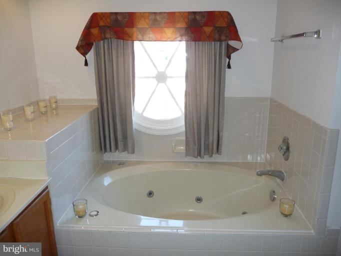 12120 Apache Tears Circle Laurel, MD 20708 - Photo 16 of 30 a bathroom with a bathtub and a shower