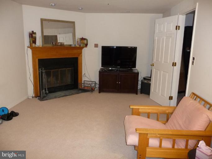 12120 Apache Tears Circle Laurel, MD 20708 - Photo 25 of 30 a living room with furniture and a flat screen tv