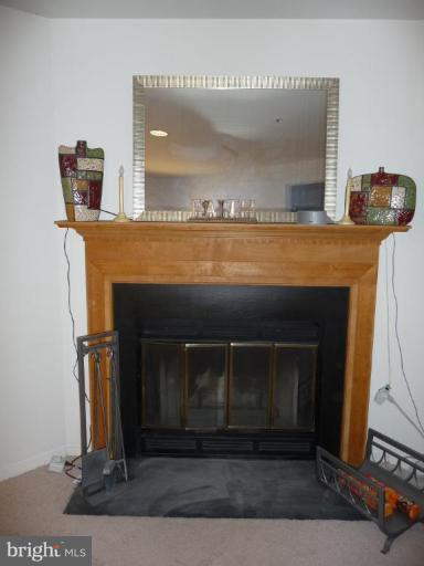 12120 Apache Tears Circle Laurel, MD 20708 - Photo 26 of 30 a living room with furniture and a fireplace