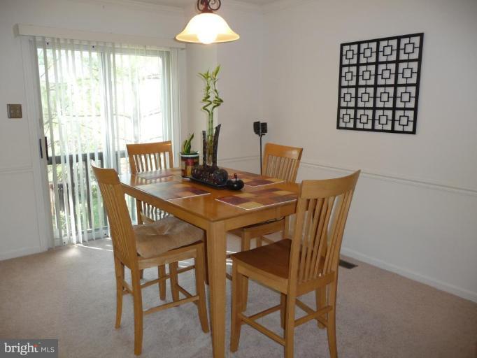 12120 Apache Tears Circle Laurel, MD 20708 - Photo 6 of 30 a view of a dining room with furniture and a window