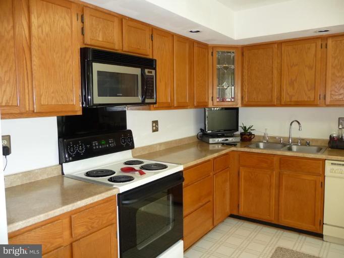 12120 Apache Tears Circle Laurel, MD 20708 - Photo 8 of 30 a kitchen with stainless steel appliances a stove microwave and sink