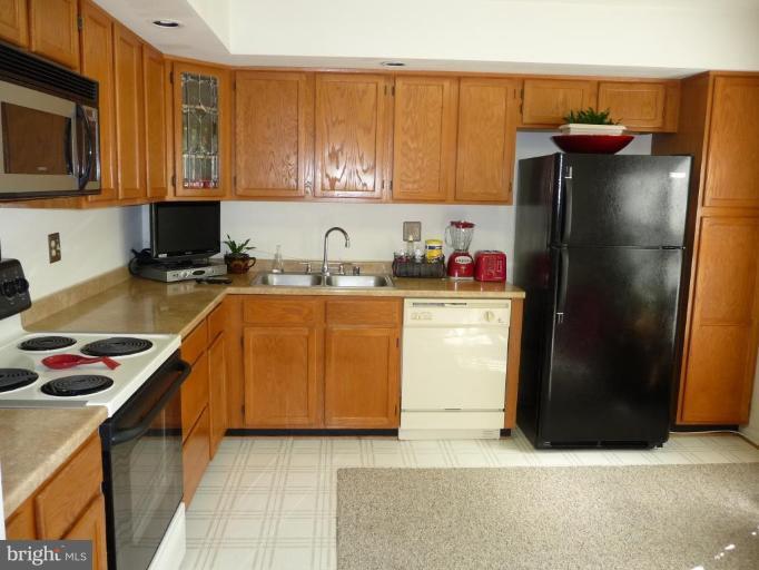 12120 Apache Tears Circle Laurel, MD 20708 - Photo 9 of 30 a kitchen with stainless steel appliances granite countertop a refrigerator stove and sink