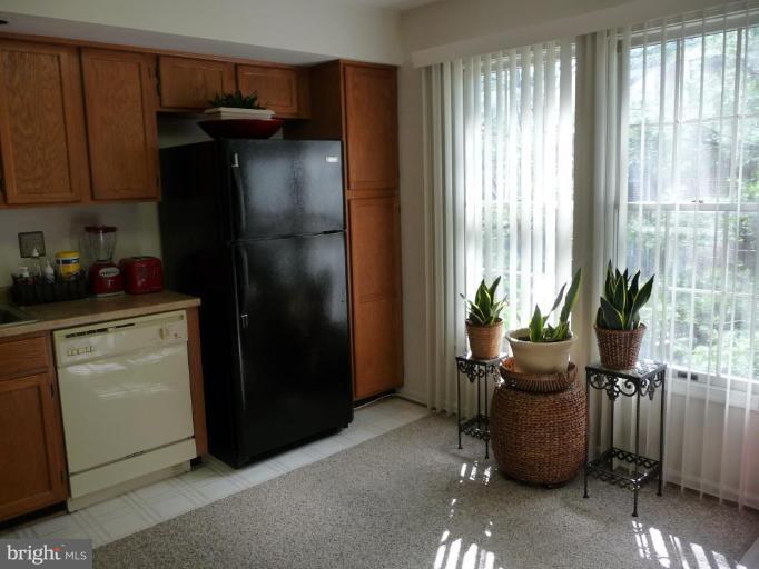12120 Apache Tears Circle Laurel, MD 20708 - Photo 10 of 30 a kitchen with stainless steel appliances a refrigerator and a sink