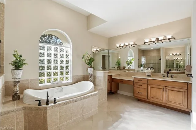 a spacious bathroom with a granite countertop tub sink and mirror