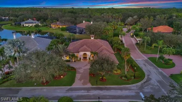 a view of a patio with table and chairs under an umbrella