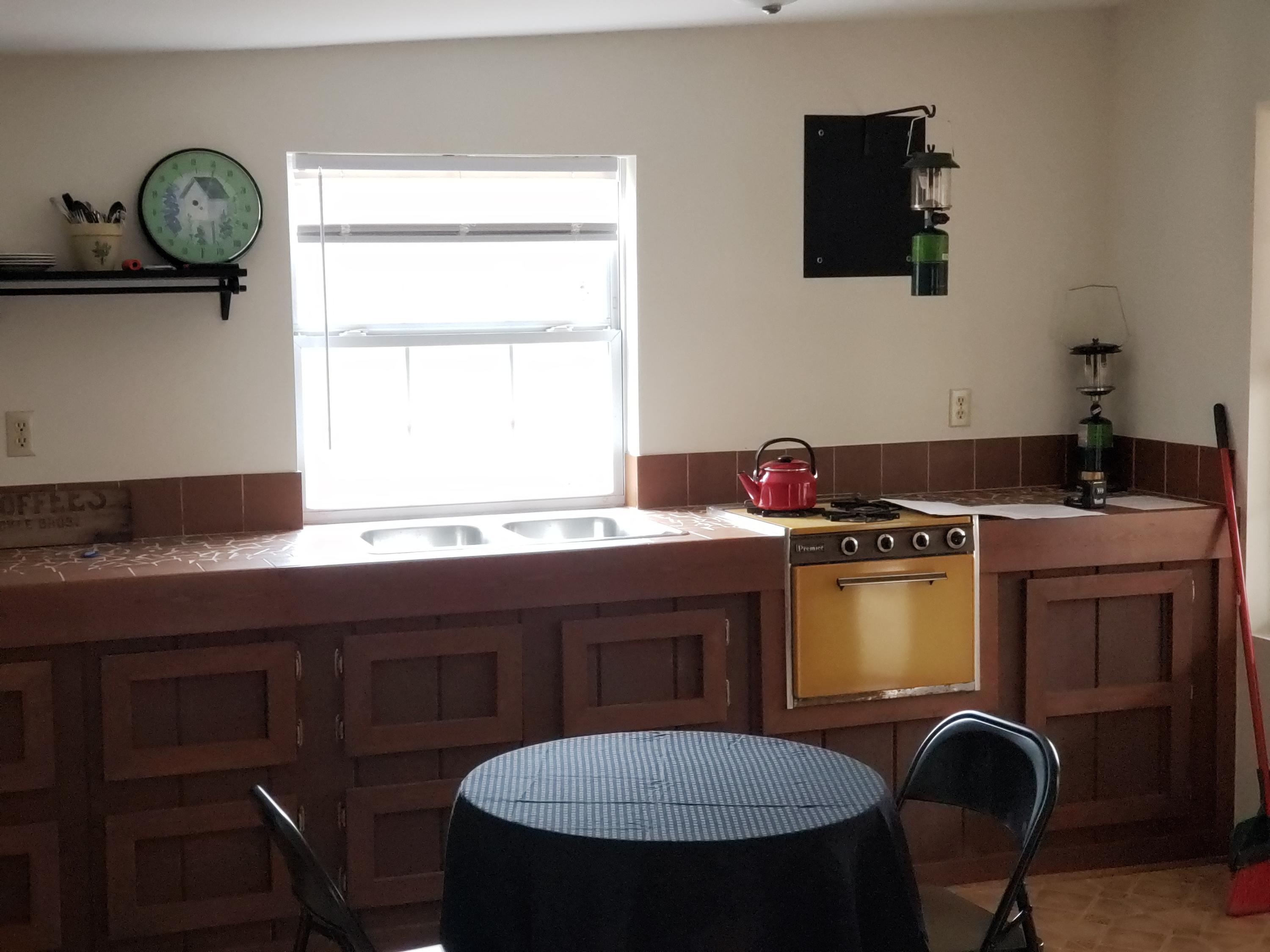410 Peach Road Henry, VA 24102 - Photo 2 of 12 a kitchen with a table chairs sink and stove