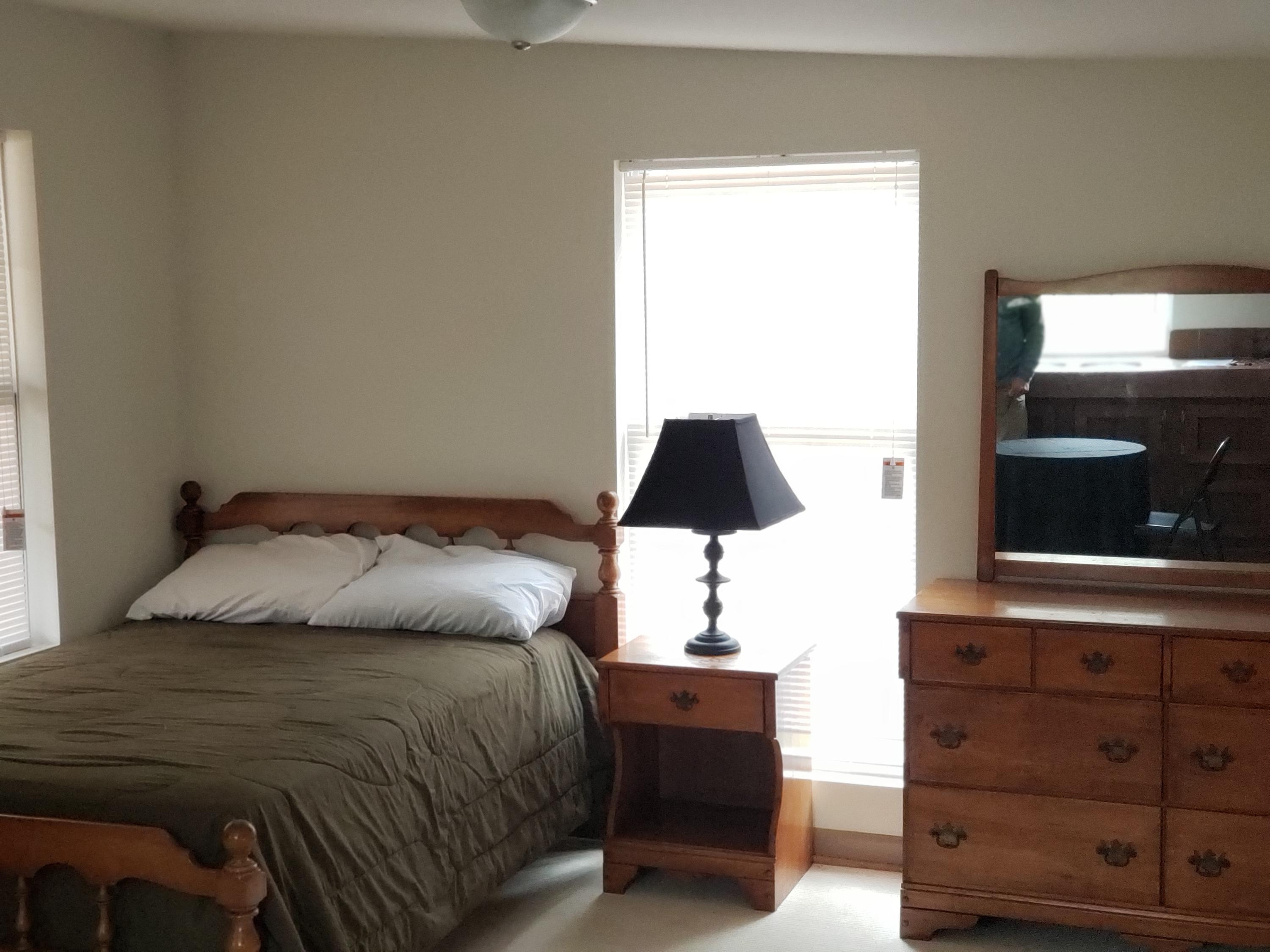 410 Peach Road Henry, VA 24102 - Photo 5 of 12 a bedroom with a bed and a flat tv screen on a dresser