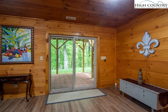 a room with painting on the wall and a large window