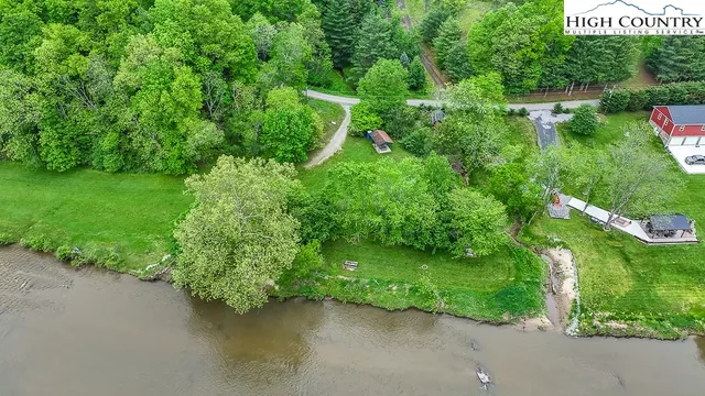 a backyard of a house with a yard and lake view