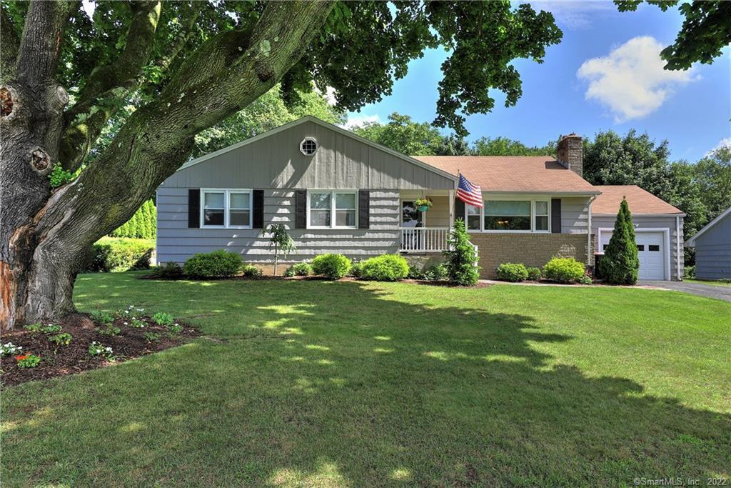 a front view of house with yard and green space