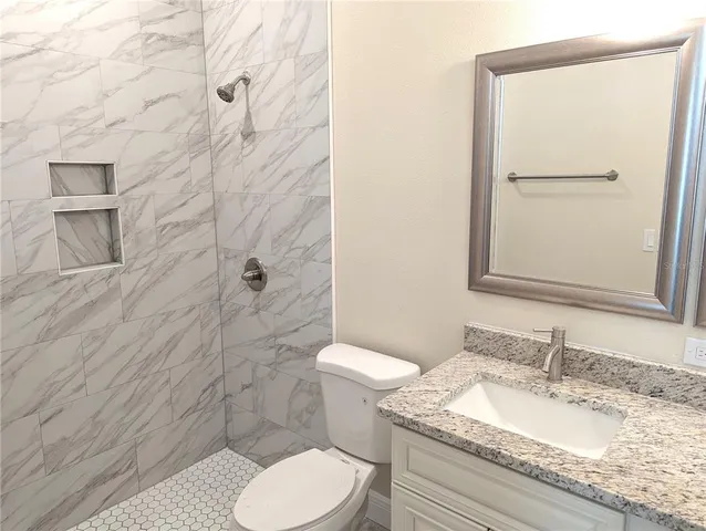 a white toilet and shower in a bathroom