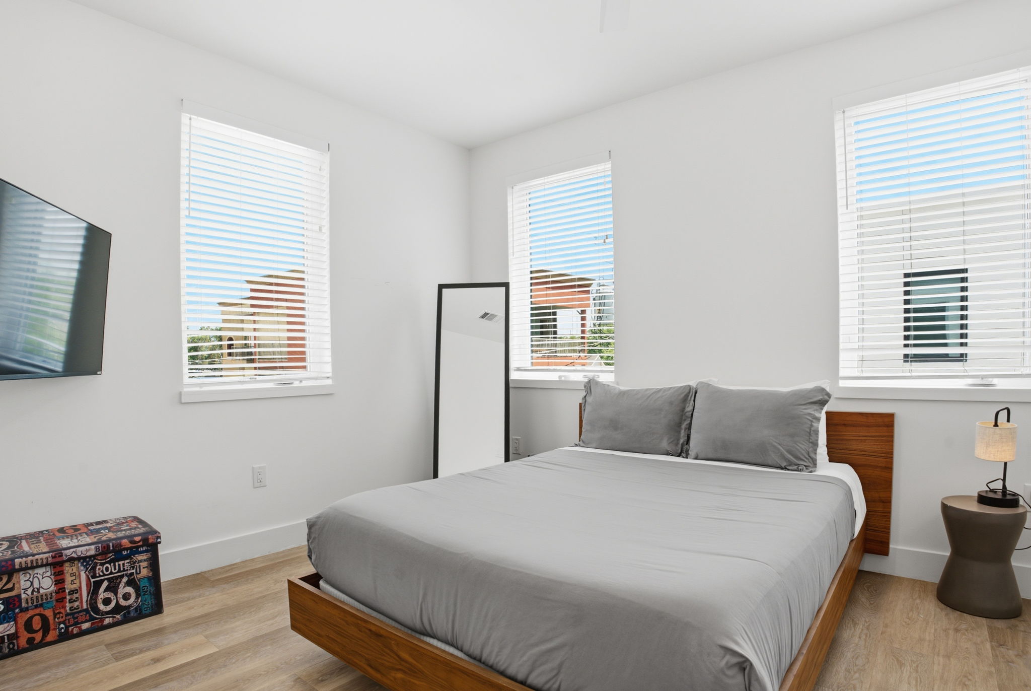 2709 East 5th Street, Unit 1306 Austin, TX 78702 - Photo 9 of 28 Well-lit sleeping quarters feature two bright windows, hard surface flooring, and minimalist design.