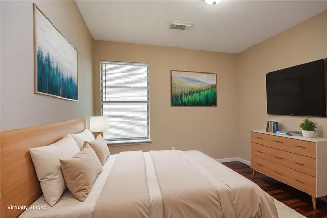 a bedroom with a bed and a flat screen tv