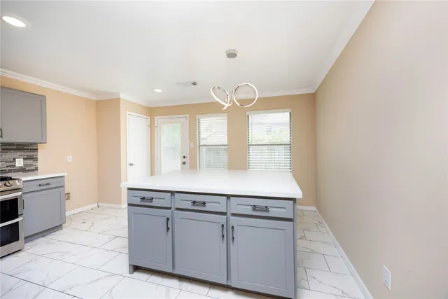 a kitchen with cabinets and window