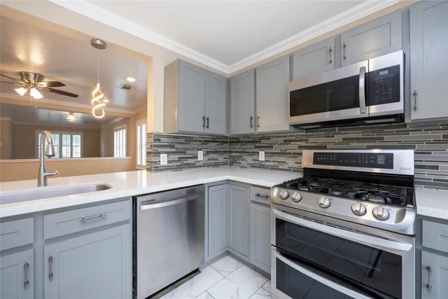 a kitchen with stainless steel appliances granite countertop a stove and a sink