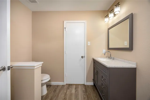 a bathroom with a toilet a sink and mirror