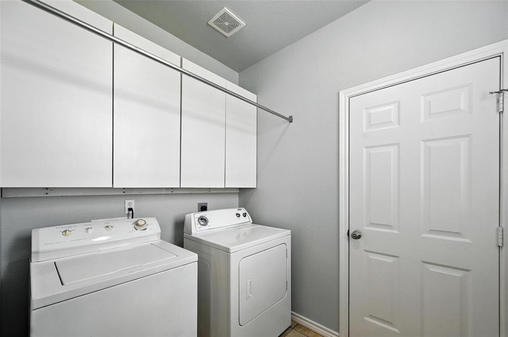 6659 Meadow Ridge Circle Nevada, TX 75173 - Photo 13 of 27 Laundry room featuring cabinet space and washer and dryer