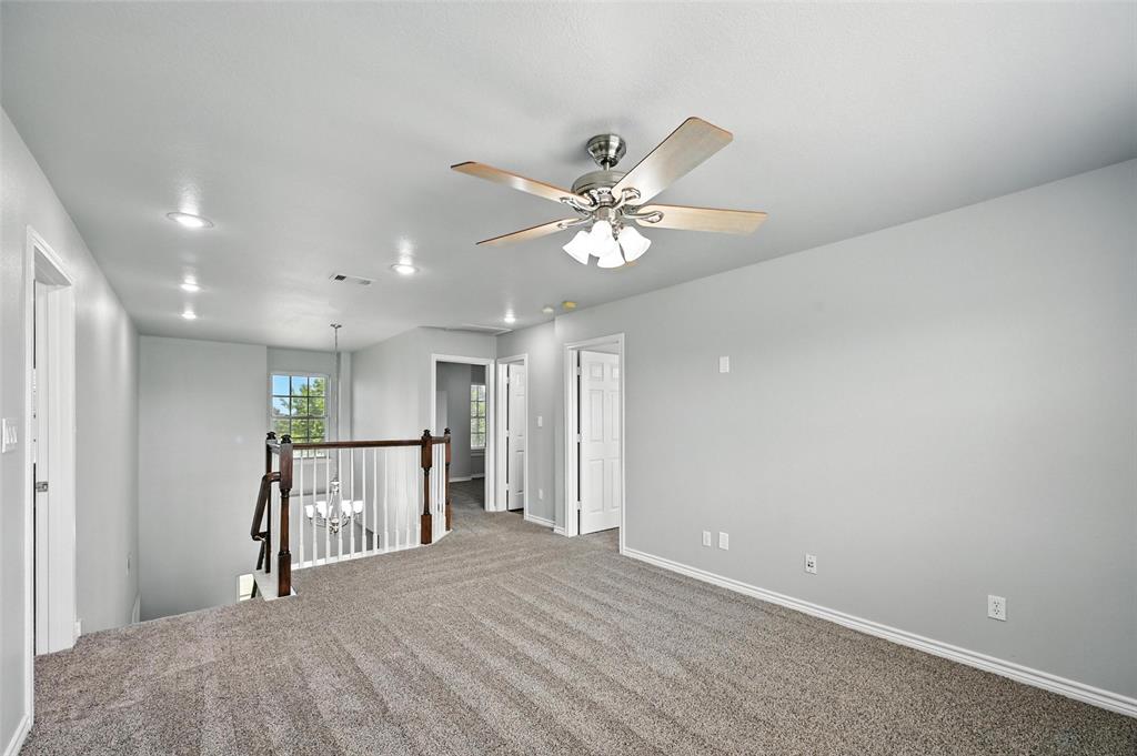 6659 Meadow Ridge Circle Nevada, TX 75173 - Photo 16 of 27 Empty room featuring carpet flooring and a ceiling fan