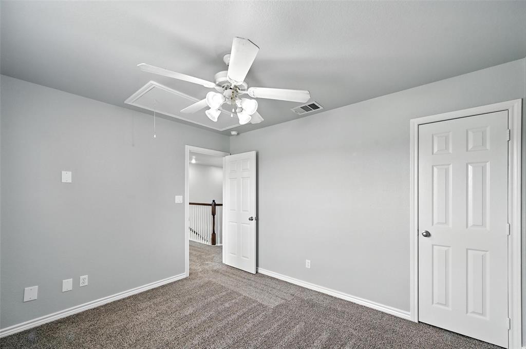 6659 Meadow Ridge Circle Nevada, TX 75173 - Photo 18 of 27 Unfurnished bedroom with attic access, carpet, and a ceiling fan