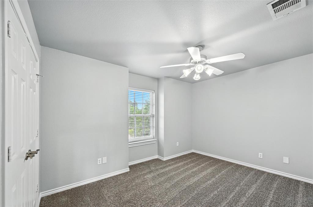 6659 Meadow Ridge Circle Nevada, TX 75173 - Photo 20 of 27 Spare room featuring a ceiling fan and dark colored carpet