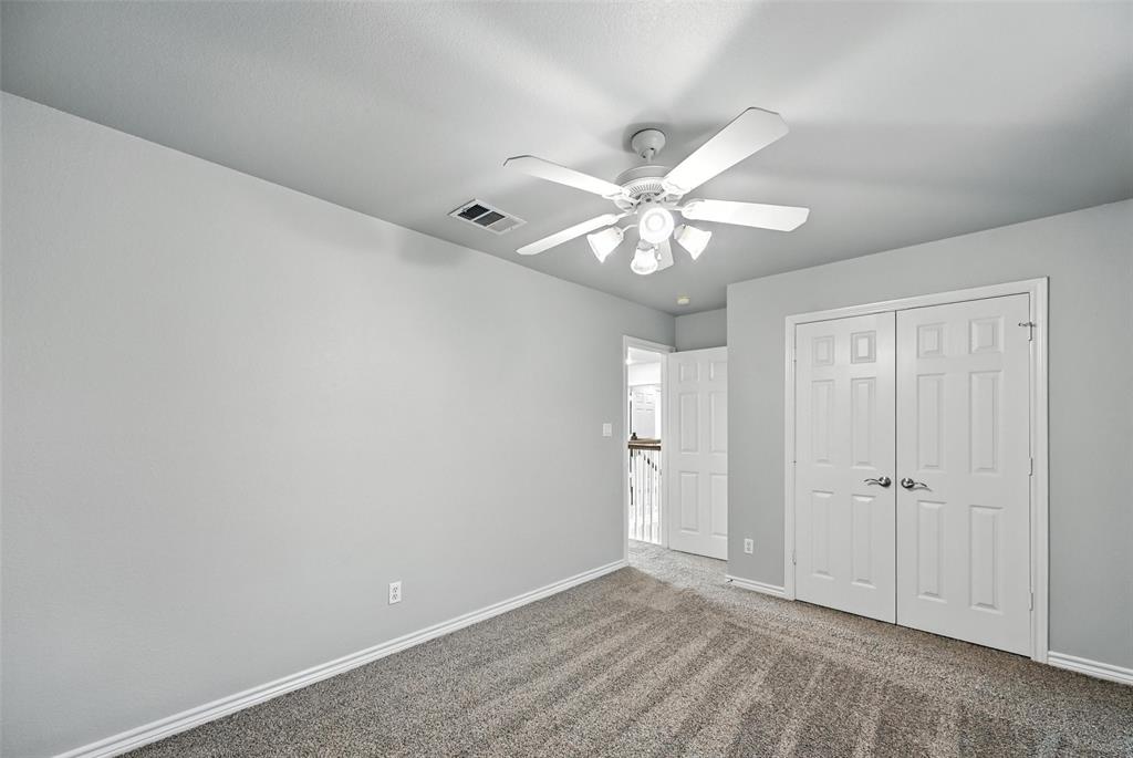 6659 Meadow Ridge Circle Nevada, TX 75173 - Photo 21 of 27 Unfurnished bedroom featuring carpet flooring, a closet, and a ceiling fan