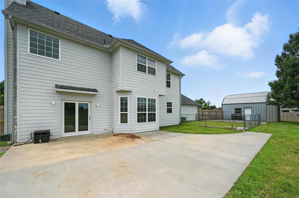 6659 Meadow Ridge Circle Nevada, TX 75173 - Photo 26 of 27 Back of house with a patio and roof with shingles