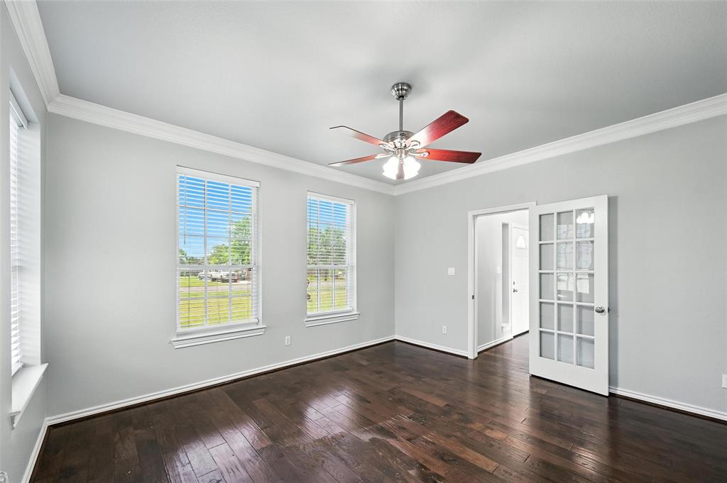 6659 Meadow Ridge Circle Nevada, TX 75173 - Photo 5 of 27 Empty room featuring dark wood-type flooring, ornamental molding, and ceiling fan